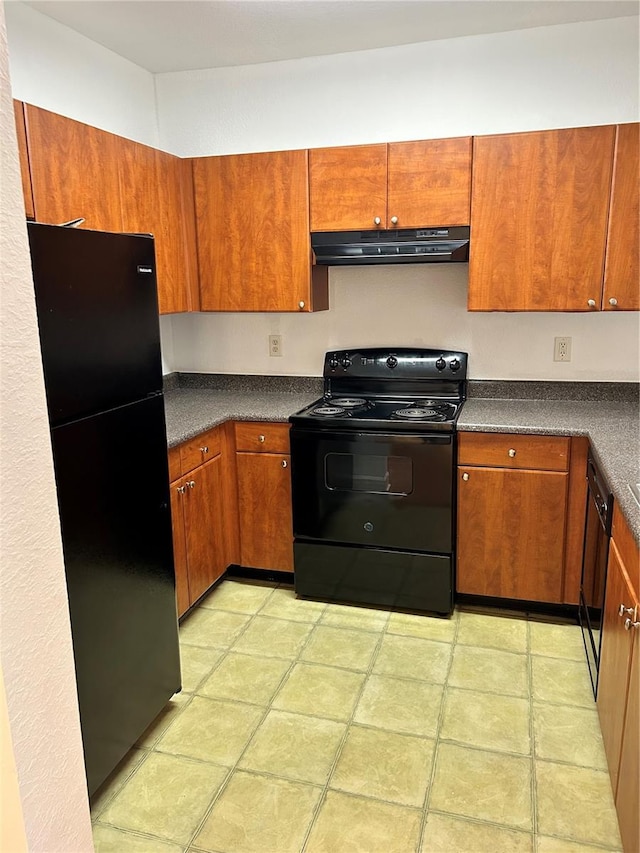 kitchen featuring fume extractor, light tile flooring, and black appliances