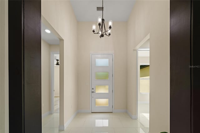 tiled entryway featuring a chandelier