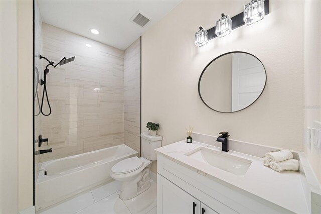 full bathroom featuring tile patterned floors, toilet, tiled shower / bath combo, and vanity