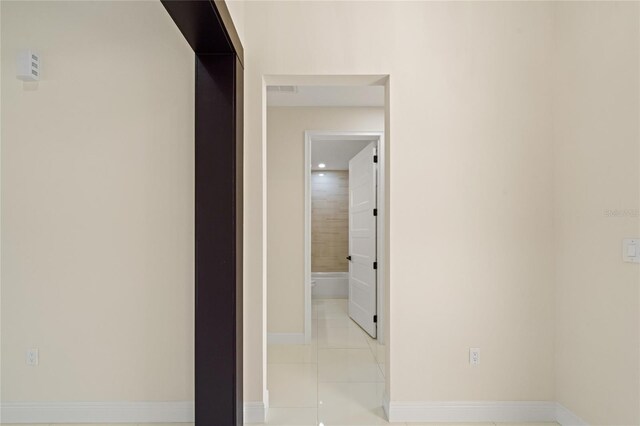 hallway featuring light tile patterned flooring