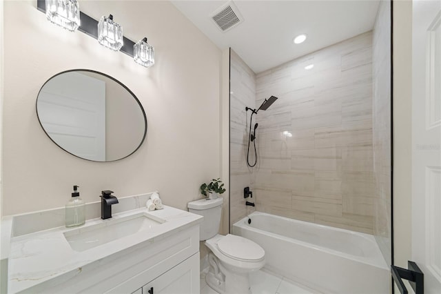 full bathroom with tiled shower / bath, toilet, and vanity