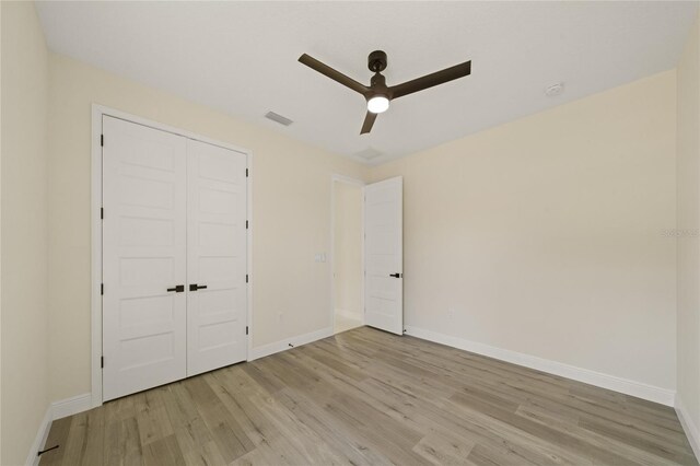 unfurnished bedroom featuring a closet, ceiling fan, and light hardwood / wood-style flooring