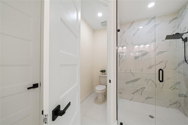 bathroom featuring tile patterned flooring, toilet, and a shower with shower door