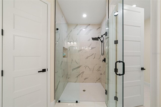 bathroom featuring a shower with door