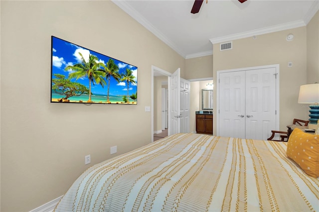 bedroom featuring ceiling fan, connected bathroom, ornamental molding, and a closet