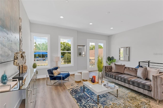 living room with light wood-type flooring and french doors