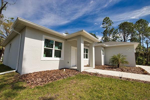 ranch-style home with a front lawn