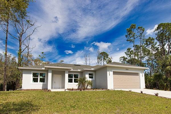 ranch-style home with a front lawn and a garage