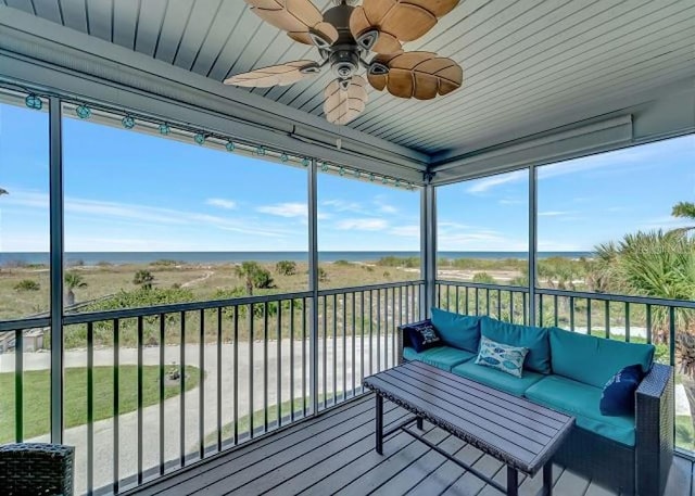 deck with a water view, outdoor lounge area, and a ceiling fan