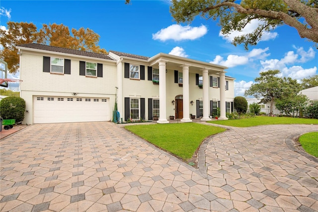 view of front of house with a front lawn and a garage