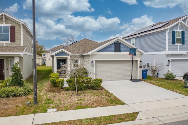 view of front of home with solar panels, a front yard, and a garage