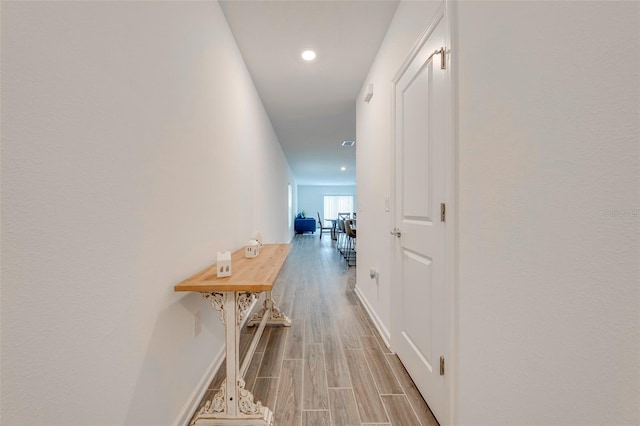 corridor with light wood-type flooring