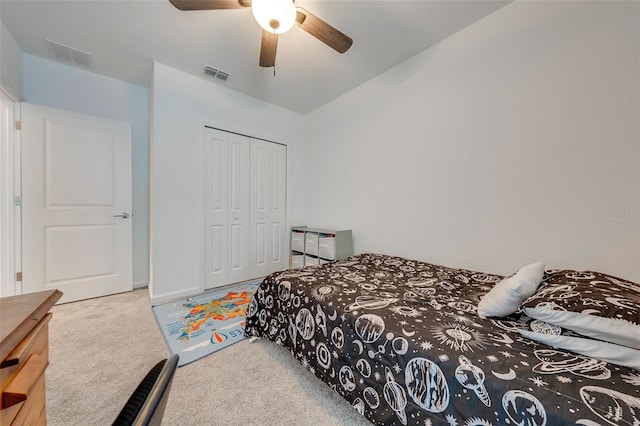 bedroom with light colored carpet, a closet, and ceiling fan