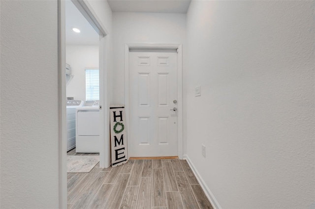 foyer featuring light hardwood / wood-style floors and washing machine and clothes dryer