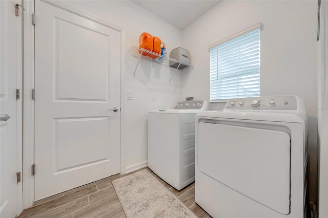 laundry room featuring washer and dryer and light wood-type flooring