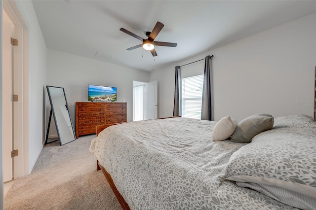 bedroom with ceiling fan and light colored carpet