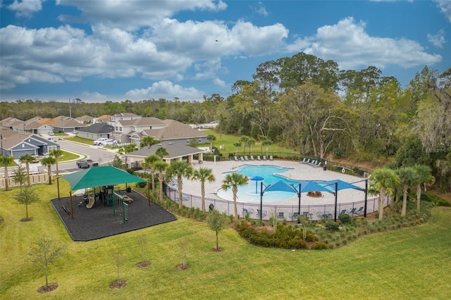 view of swimming pool featuring a playground and a yard