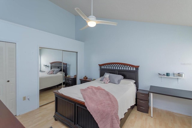 bedroom with light hardwood / wood-style floors, ceiling fan, and high vaulted ceiling