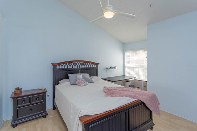 bedroom featuring lofted ceiling, ceiling fan, and light wood-type flooring