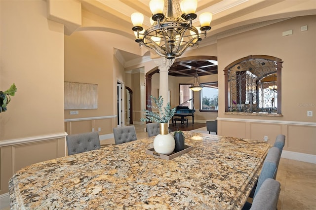 dining area featuring beam ceiling, an inviting chandelier, decorative columns, and light tile floors