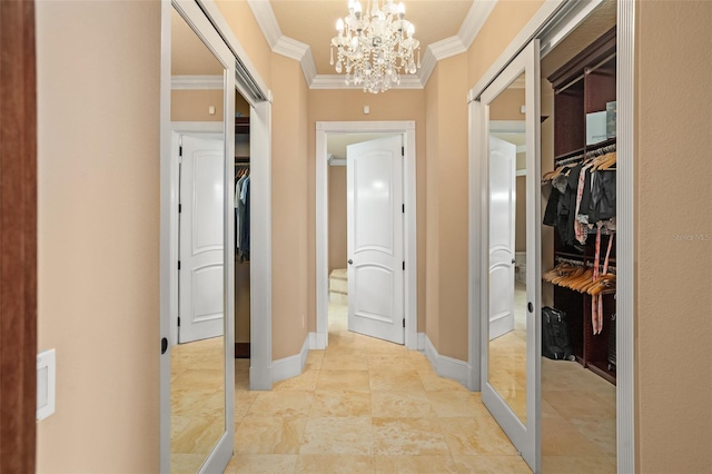 hall featuring light tile floors, a notable chandelier, and crown molding