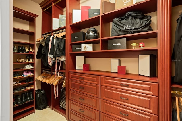 walk in closet with tile floors