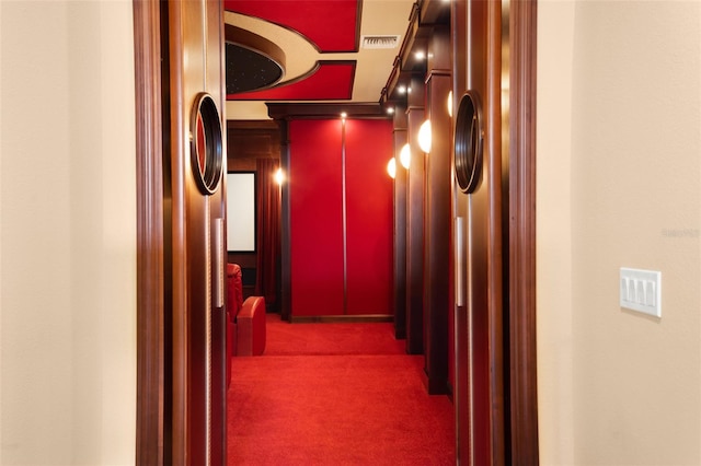 hallway featuring dark colored carpet