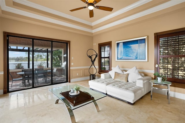 living room featuring light tile floors, ceiling fan, and a healthy amount of sunlight