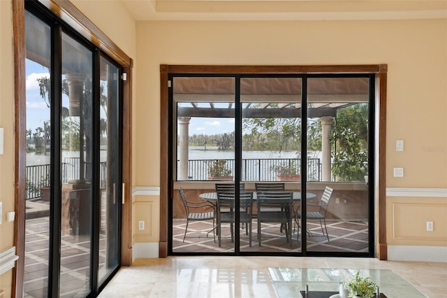 doorway to outside featuring light tile flooring