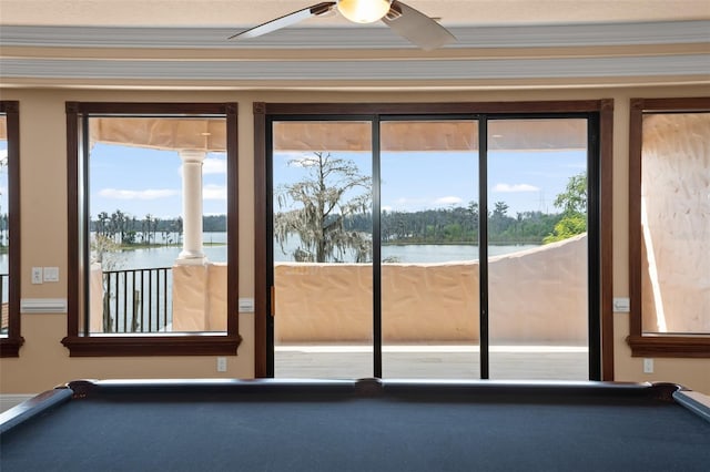 doorway with pool table, ceiling fan, and a water view