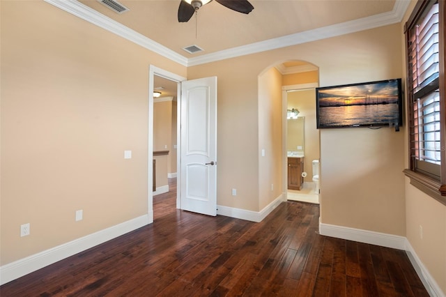 empty room featuring ceiling fan, crown molding, and dark wood-type flooring