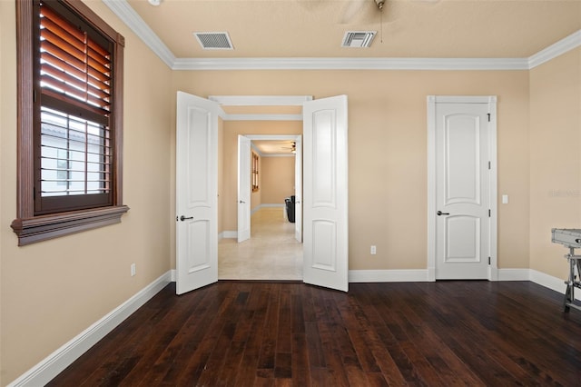 unfurnished bedroom featuring crown molding and dark hardwood / wood-style floors