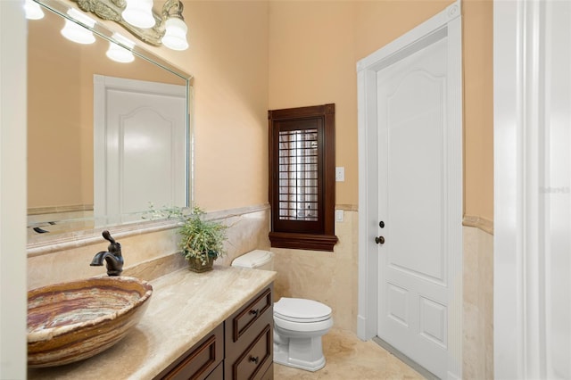 bathroom featuring vanity, tile flooring, and toilet