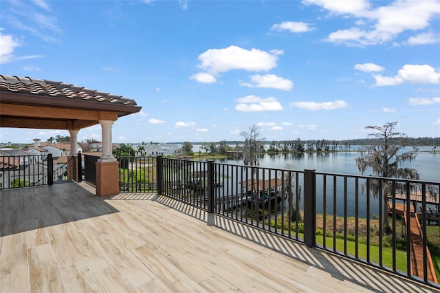 deck with a gazebo and a water view