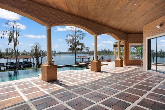 view of terrace featuring a dock and a water view