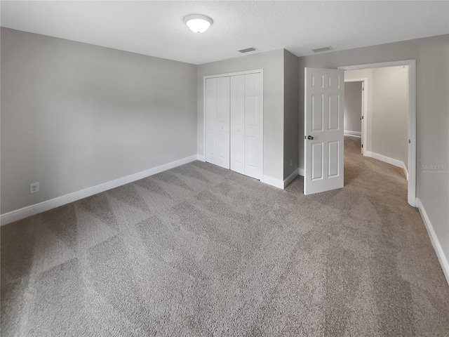 unfurnished bedroom with carpet floors and a closet