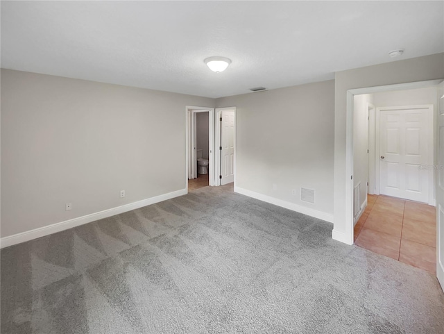 empty room featuring light colored carpet