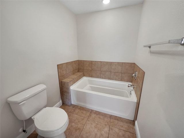 bathroom featuring tile floors, toilet, and a washtub