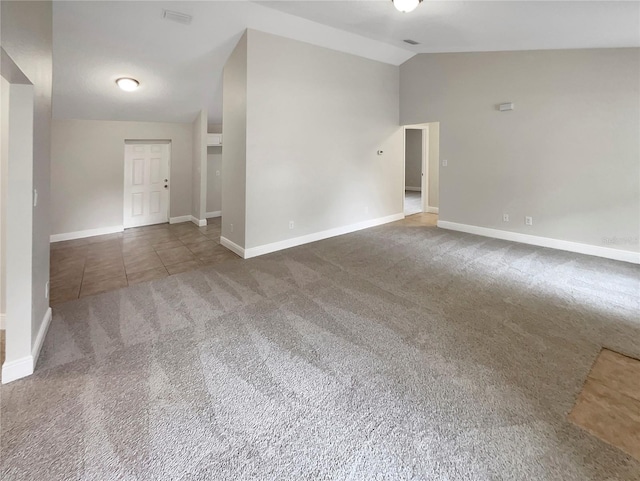 empty room featuring dark carpet and vaulted ceiling