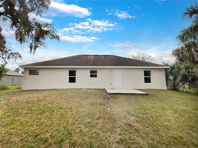 back of property featuring a yard and a patio