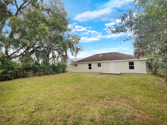 rear view of property with a lawn