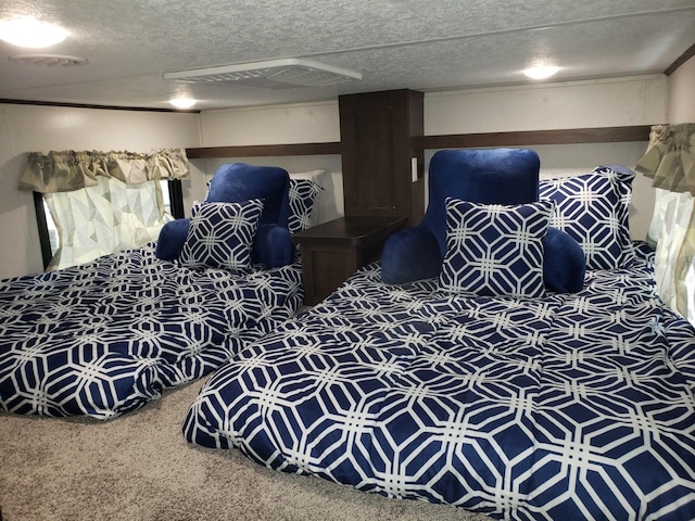 carpeted bedroom featuring a textured ceiling