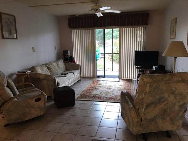 tiled living room featuring ceiling fan