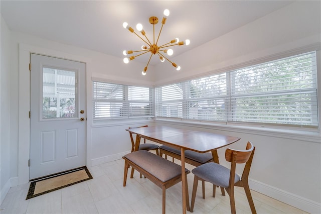 tiled dining area featuring a notable chandelier and plenty of natural light