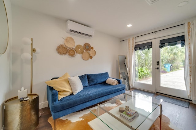 living room with an AC wall unit, french doors, and hardwood / wood-style flooring