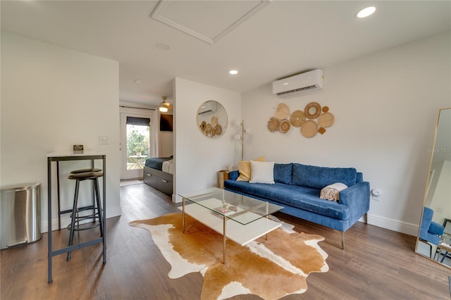 living room with a wall mounted air conditioner and dark hardwood / wood-style floors