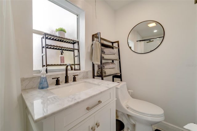 bathroom featuring toilet and vanity