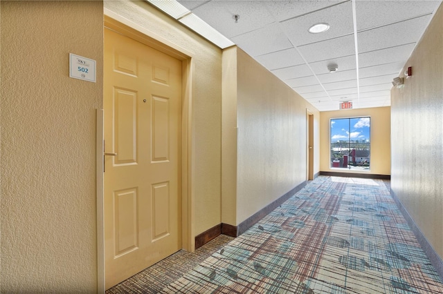 corridor featuring a paneled ceiling