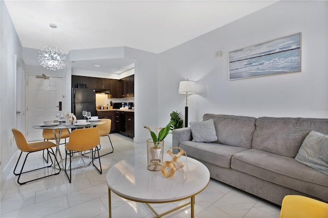 living room featuring a notable chandelier and light tile floors