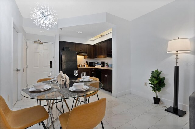 dining room with an inviting chandelier and light tile floors